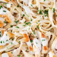 Chicken Alfredo · Fettucine in rich and creamy Alfredo sauce topped with grilled sliced chicken and fresh Parm...