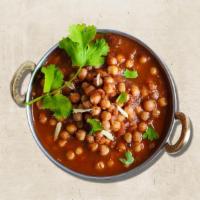 Chickpea Charm (Vegan) · Flavorful Indian curry with boiled chickpea loaded with spices and tasteful gravy served wit...