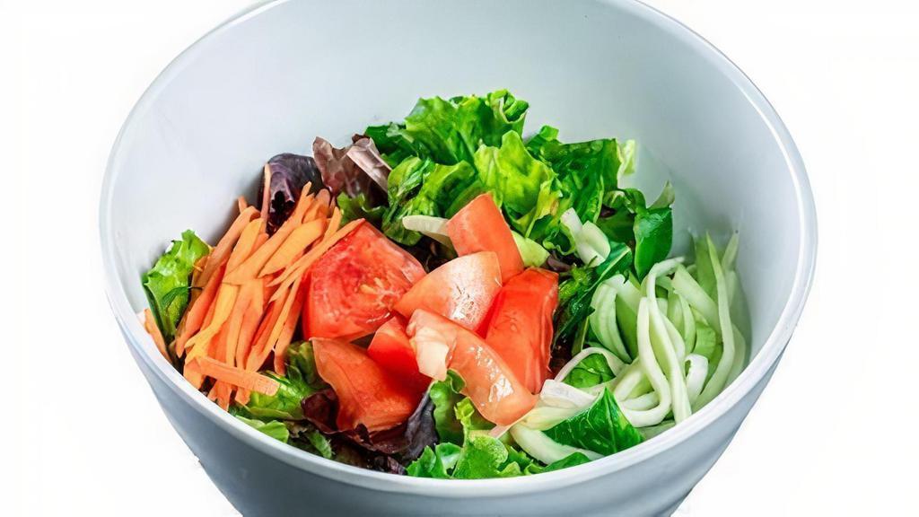 (G064) Green Salad · Mixed greens, carrots, cucumbers, tomatoes and ginger dressing.
