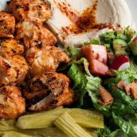 Chicken Tawook · chicken breast, garlic sauce, wild cucumber pickles. Served with pita bread + your choice of...