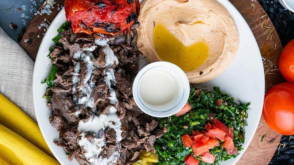 Beef Shawarma · prime top round, grilled tomato, parsley, onion, sumac, wild cucumber pickles. Served with pita bread + your choice of one dip & one salad - hummus, spicy hummus, baba ghannouj | open sesame salad, fattoush, tabouleh