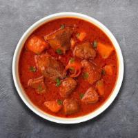 Lamb Vindaloo · Lamb cooked in rich tangy gravy with curry leaves, potatoes and coconut milk.