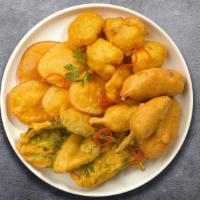 Mixed Vegetable Pakora · Shredded farm fresh spring vegetables mixed with basin flour and deep fried. Served with spi...