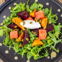 Baby Beets · Arugula, baby gold and red beets, melon, whipped goat cheese, champagne vinaigrette, pepitas