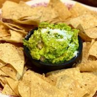 Chips And Guacamole · Classic guacamole made with onion, cilantro, tomatoes, and a dash of lime.