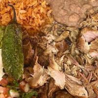 Carnitas Plate · Served with rice & beans, grilled onion, pineapple, and a  fried jalapeño and a side of  gua...