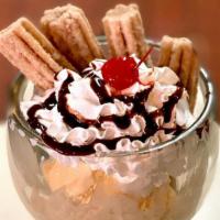Churro Sundae · Cinnamon churros served with dulce-de-leche ice cream topped with whipped cream, caramel or ...