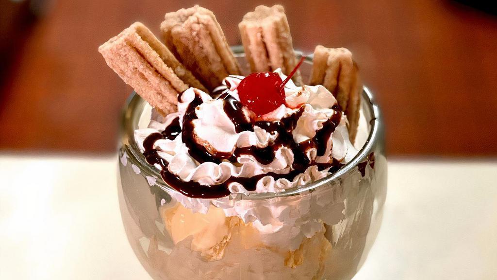 Churro Sundae · Cinnamon churros served with dulce-de-leche ice cream topped with whipped cream, caramel or chocolate drizzle.