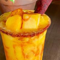 Mango Chiller · Frozen mango drink with a tajín rim, chamoy swirl, garnished with a tamarind candy.