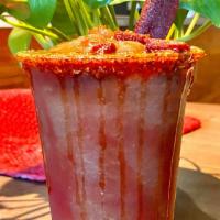 Tamarindo Chiller · Frozen tamarind drink with a tajín rim, chamoy swirl, garnished with a tamarind candy.