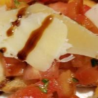 Bruschetta · Toasted homemade bread, topped with tomatoes and olive oil, garlic, and shaved parmesan.