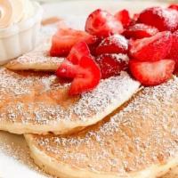 Fresh Strawberry Pancakes · Buttermilk pancakes topped with fresh sweet strawberries, dusted with powdered sugar, served...