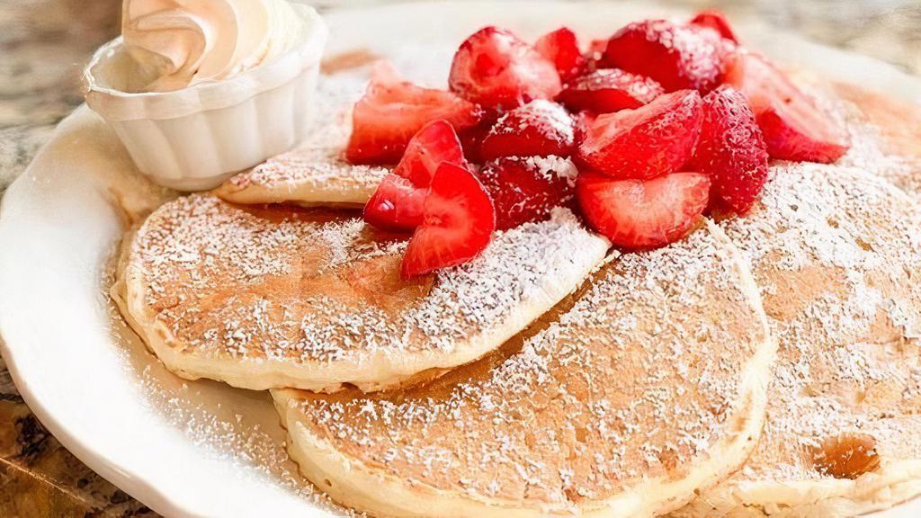 Fresh Strawberry Pancakes · Buttermilk pancakes topped with fresh sweet strawberries, dusted with powdered sugar, served with real whipped cream and whipped butter.