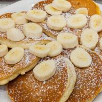 Banana Pancakes · Ripe bananas griddled into pancakes and then topped with more sliced bananas; dusted with po...