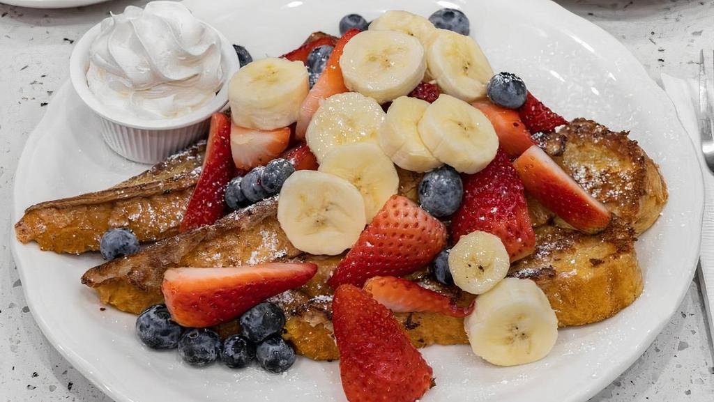 San Diego French Toast · Grilled until golden brown and garnished with the freshest sliced bananas, strawberries, and blueberries; dusted with powdered sugar, and served with real whipped cream and whipped butter.