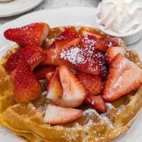 Fresh Strawberry Patch Waffle · A waffle dusted with powdered sugar, topped with fresh strawberries, served with real whippe...