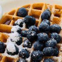 Blueberry Waffle · A waffle topped with wild blueberries; dusted with powdered sugar and served with a side of ...