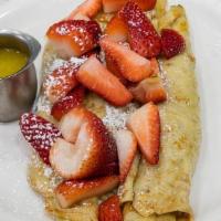 Fresh French Strawberry Crepes · Crepes are wrapped around fresh juicy strawberries, topped with more strawberries, dusted wi...