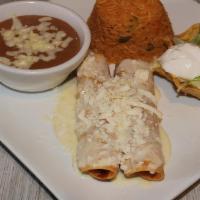 Lunch Chicken Flautas · Two crispy corn tortillas stuffed with chicken. Topped with nacho cheese and queso fresco. S...