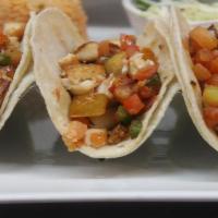 Fish Tacos · Three grilled fish tacos with pico de gallo and mama's special chipotle sauce. Served with w...