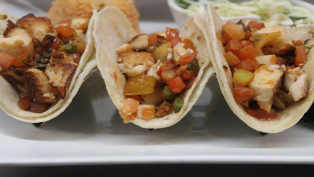Fish Tacos · Three grilled fish tacos with pico de gallo and mama's special chipotle sauce. Served with white rice and black beans.