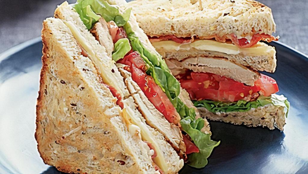 Chicken Club Sandwich · Grilled chicken breast with smoked bacon, crisp lettuce, fresh tomato and mayonnaise on sourdough bread. Served with choice of side. 990-1250 Cal.