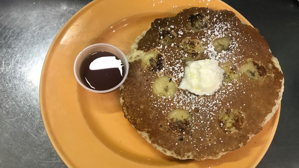 Banana Pancakes · Two pancakes served with side of butter and maple syrup.