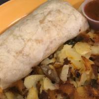 Breakfast Burrito · A flour tortilla stuffed with three scrambled eggs, cheese, and bacon or sausage. Served wit...