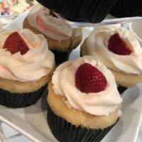 The Strawberry Shortcake · Yellow cake filled with a fresh strawberry. Topped with vanilla buttercream and a fresh stra...