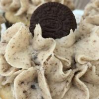 The Cookie Crumb · Yellow cake baked with cookie crumbs. Topped with cookie crumb buttercream and a mini Oreo.