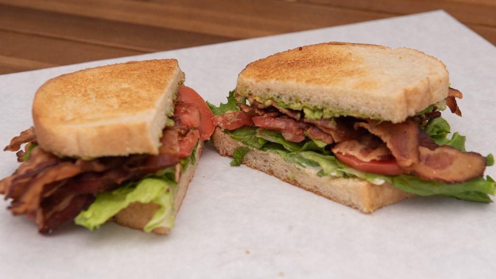 L.T. & Avocado · Stack of smoked bacon, avocado mash, green leaf lettuce, sliced tomato, mayo on toasted sourdough. Add cheese for an upcharge.