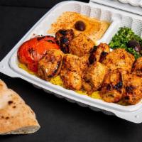 Chicken Tikka · Marinated Chicken Breast Tikka, Served with Basmati Yellow Rice, Hummus, Tabouli, and Pita B...