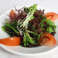 Seaweed Salad · Green salad with seaweed topped with fried wonton strips and sesame seeds.