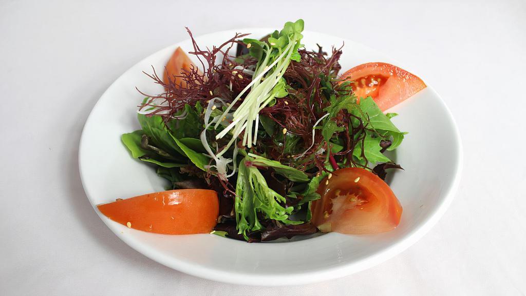 Seaweed Salad · Green salad with seaweed topped with fried wonton strips and sesame seeds.