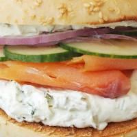 Salmon Bagel · Plain bagel with cream cheese mixed with dill and capers, smoked salmon, cucumber and red on...