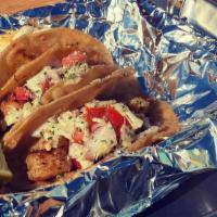 Shrimp Tacos · 3 grilled cajun shrimp tacos topped with cabbage, onion, and tomato sauce & sprinkled with p...