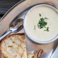 New England Clam Chowder · Clams, corn, bacon, cream, and grilled sourdough.