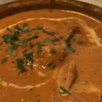 Butter Chicken · Chicken leg meat pieces roasted in the clay oven and tossed in a creamy tomato sauce.