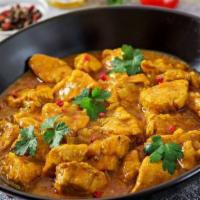 Classic Chicken Curry · Chicken cooked in onion ginger garlic gravy with mild spices.