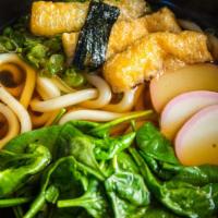 Kitsune Udon · Udon noodles, aburaage, fish cake and spinach topped with green onions and seaweed served in...