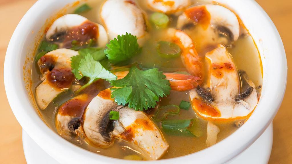Tom Yum Soup · Clear, spicy, and sour lemongrass soup, mushroom, onions, and cilantro. Choice of protein.