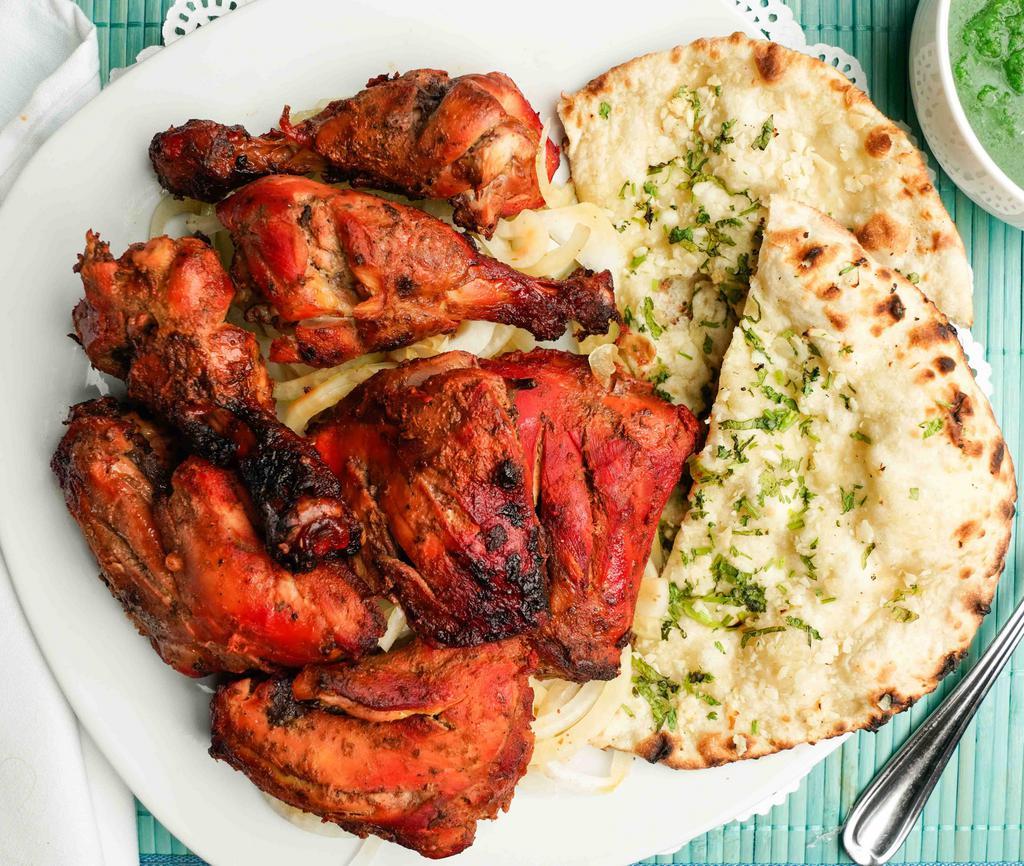 Tandoori Chicken · Chicken leg marinated with yogurt, ginger, garlic and other Indian spices, baked in tandoor oven.