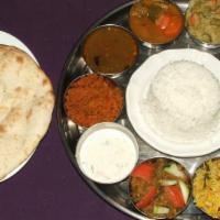 Vegetarian Thali · Assorted vegetarian dishes {3] served with rice, naan