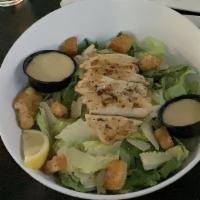 Chicken Caesar · romaine lettuce, shaved Parmesan, lemon, seasoned croutons topped with chicken.