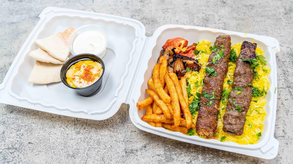 Plates · Your choice of kabab, gyro, chicken, or 4 heroes kabab, basmati rice, French fries, served with grilled tomato and onions, hummus, house garlic sauce, and pita bread.