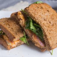 Salmon Sandwich* · Salmon, red onion, spinach, tomato, pomegranate, provolone cheese, and house spread on whole...