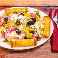 Antipasto Salad · Crisp green salad topped with Italian meats, red onions, cheeses, tomatoes, olives and peppe...