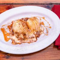 Montana Greg · Sweet cinnamon roll caramelized to perfection, topped with two scoops of ice cream and drizz...
