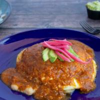 Huevos Rancheros · Two fried eggs on a toasted corn tortilla, layered with ranchero salsa and refried beans, to...