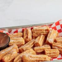 Churro Bites · Fried dough pastries dusted with cinnamon sugar and served with chocolate dipping sauce.
